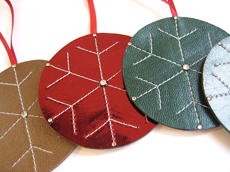 Handmade leather round stitched Christmas decorations by Emma Greenwood Handmade leather round stitched Christmas decorations by Emma Greenwood